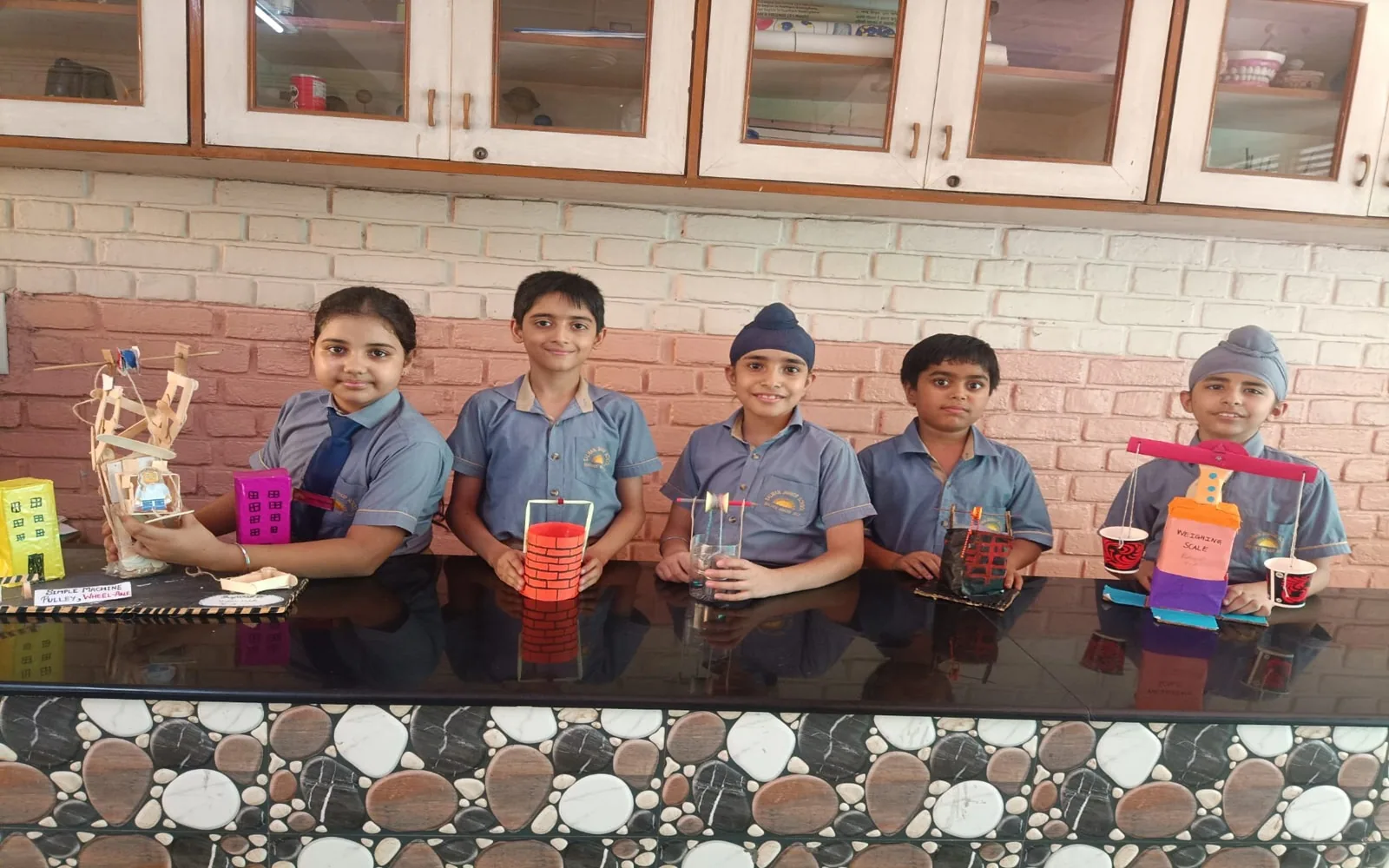 Salwan Junior School students proudly displaying trophies and projects